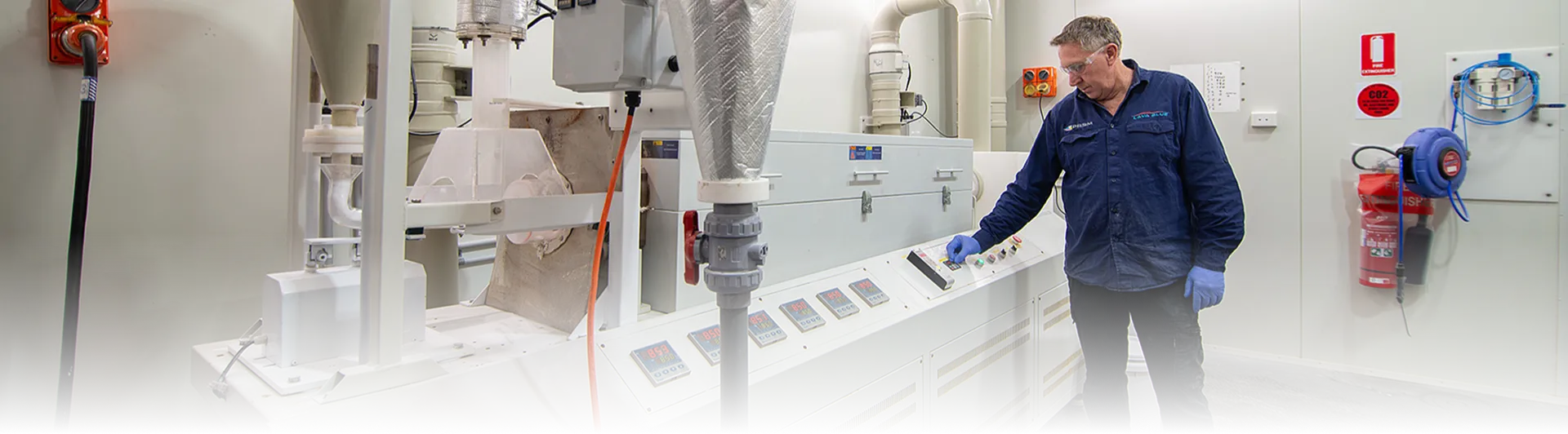 A Lava Blue operator at the control panel of the calcination furnace inside the PRiSM plant